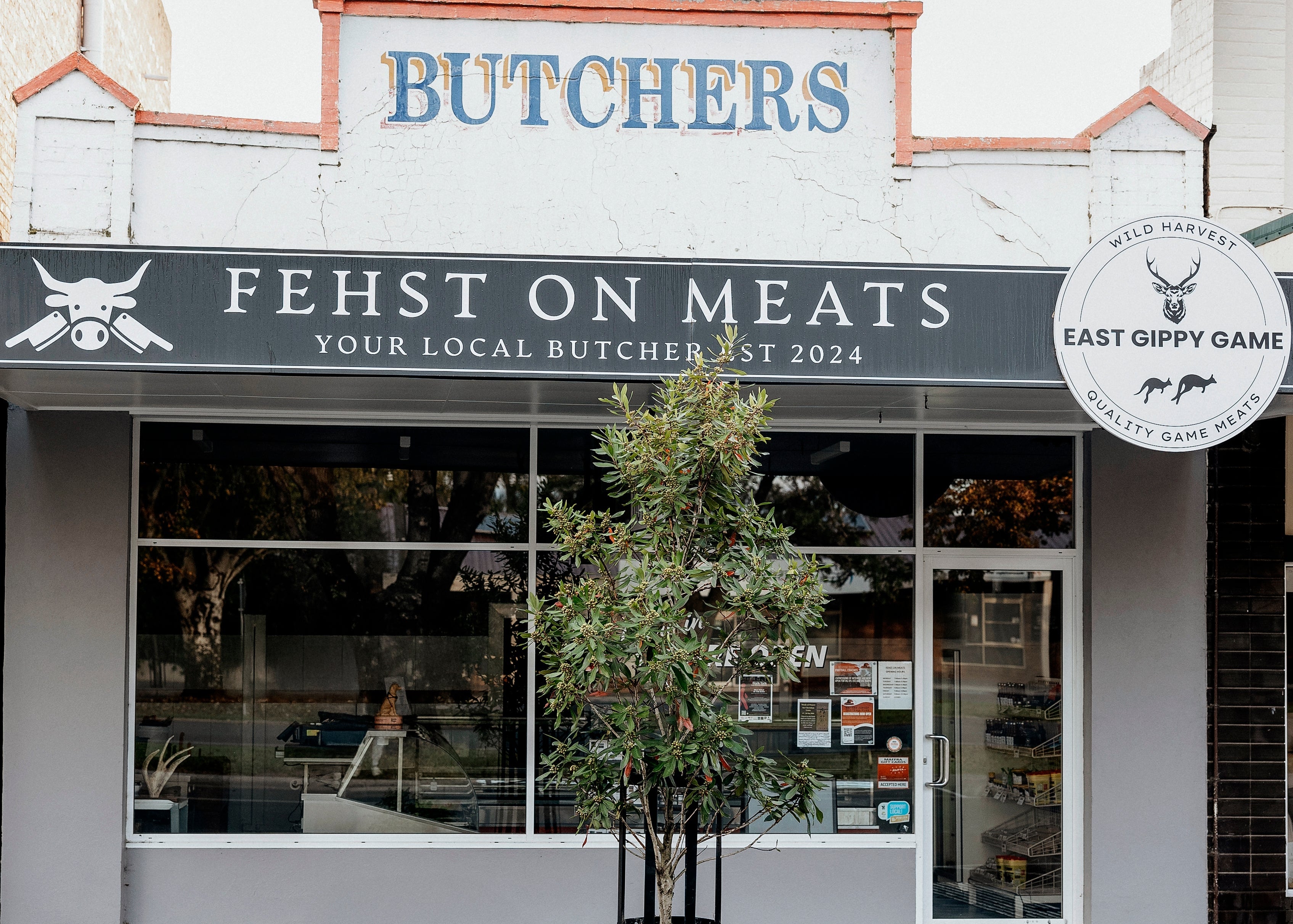 Butcher shop exterior with 'Fehst on Meats' sign and 'East Gippy Game' logo.