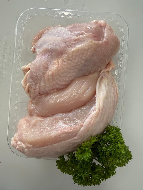 Fresh chicken breast fillets in a clear tray with parsley, prepared at Fehst on Meats Maffra